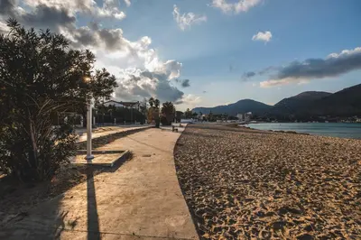 a path on a beach next to a body of water at LuminHouse Mondello Limone in Mondello