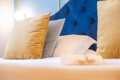 a close up of a bed with pillows at Family Affair Luxury Rooms&Suites in Palermo