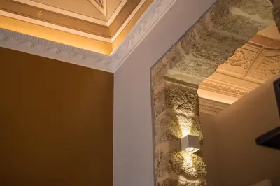 a ceiling in a room with a stone pillar at Family Affair Luxury Rooms&Suites in Palermo