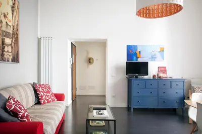 a living room with a red couch and a blue dresser at APT Ballarò House - Superior Apartment in Palermo