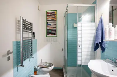 a bathroom with a toilet and a glass shower at APT Ballarò House - Superior Apartment in Palermo
