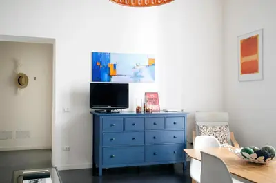 a living room with a blue dresser and a tv at APT Ballarò House - Superior Apartment in Palermo
