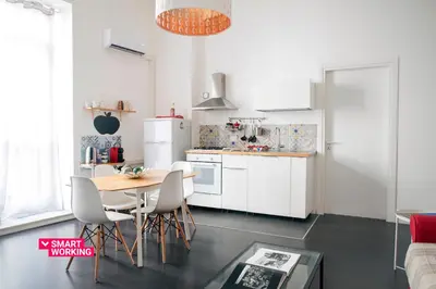 a kitchen and dining room with a table and chairs at APT Ballarò House - Superior Apartment in Palermo