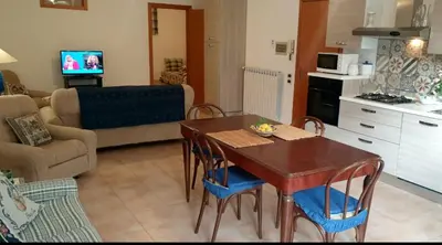 a kitchen and living room with a table and chairs at Casa dolce Casa in Sambuca di Sicilia