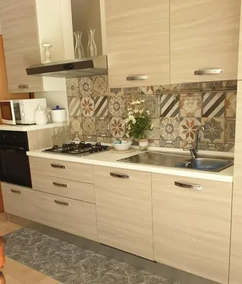 a kitchen with white cabinets and a sink and a stove at Casa dolce Casa in Sambuca di Sicilia