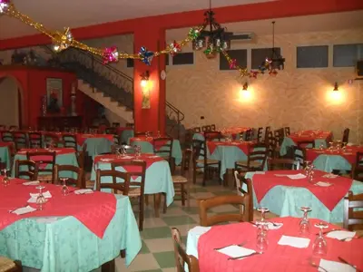 a dining room with red and blue tables and chairs at Agriturismo La Targa in Buonfornello