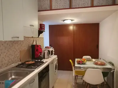 a kitchen with a sink and a stove top oven at Pretty house in Palermo