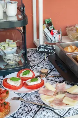 a table topped with plates of food on a counter at Ciccio Rooms and breakfast - Self check-in in Palermo