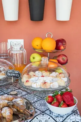 two plates of food on a table with fruits and vegetables at Ciccio Rooms and breakfast - Self check-in in Palermo