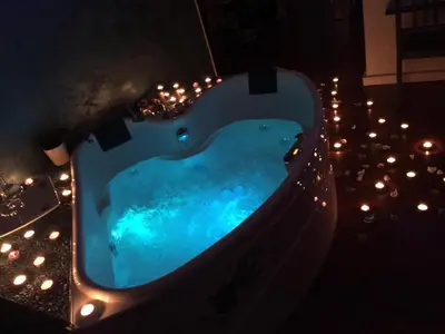 a swimming pool at night with lights around it at SuiteSicily Rooms Palermo in Altavilla Milicia