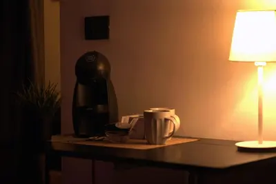 a coffee maker and a cup on a table at SuiteSicily Rooms Palermo in Altavilla Milicia