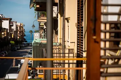 a view from a balcony of a street with buildings at SuiteSicily Rooms Palermo in Altavilla Milicia