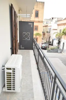 a white air conditioner sitting on the side of a balcony at Caporama in Terrasini