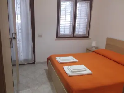 a bedroom with a bed with two towels on it at fabrizio e caterina in San Vito lo Capo