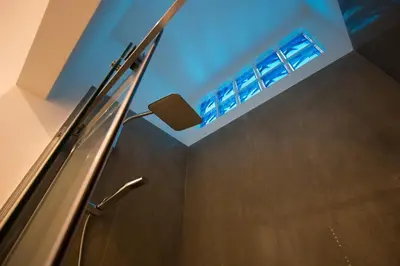 a bathroom with a shower with a blue ceiling at Le Casette di Marcì in Palermo