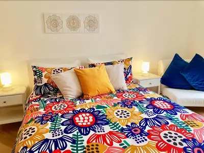 a bedroom with a colorful bed with pillows at Le Casette di Marcì in Palermo