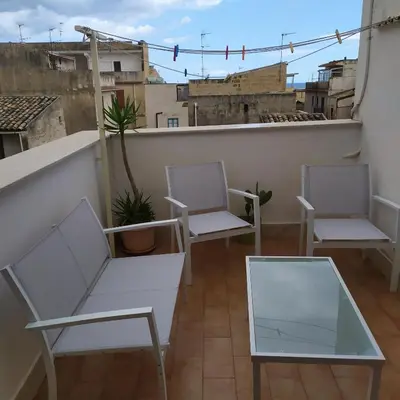 two chairs and a table on a balcony at Casa Vacanza Isola sul Mare in Castellammare del Golfo