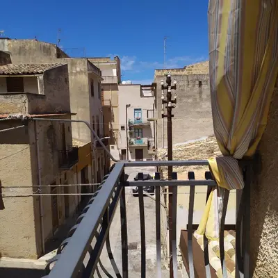 a balcony with a view of a city at Casa Vacanza Isola sul Mare in Castellammare del Golfo