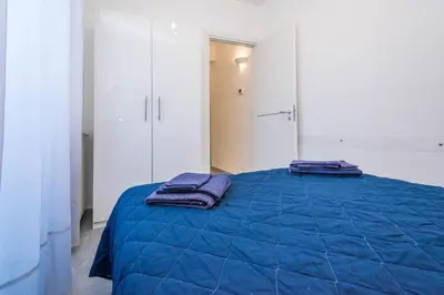 a bedroom with a blue bed with two towels on it at Villa Sara in Lascari