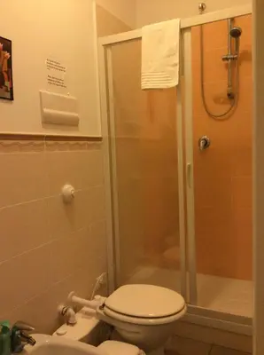 a bathroom with a shower with a toilet and a sink at Vado Al Massimo in Palermo