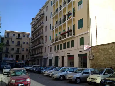 a row of cars parked in front of a building at Vado Al Massimo in Palermo