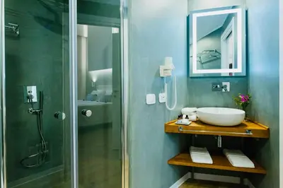 a bathroom with a sink and a shower at Bellaroto Suite & Spa - Charming Boutique Rooms in Palermo