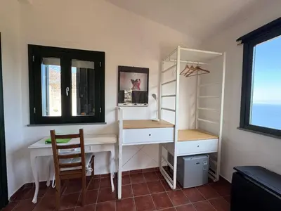 a room with a desk and a chair and a window at Baglio La Luna - B&B in San Vito lo Capo