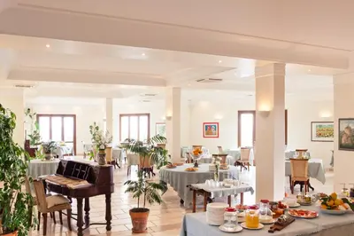a dining room with tables with food on them at Torre Bennistra in Scopello