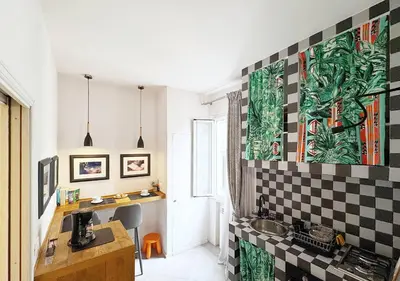 a kitchen with a sink and a checkerboard wall at Solemar Sicilia - Valuan Luxury Home in Palermo