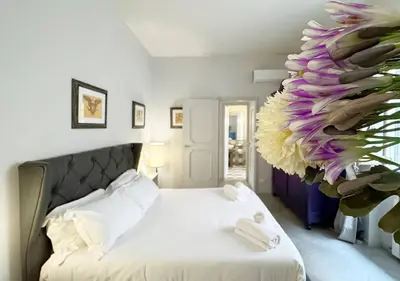 a bedroom with a bed with a large flower on the wall at Solemar Sicilia - Valuan Luxury Home in Palermo