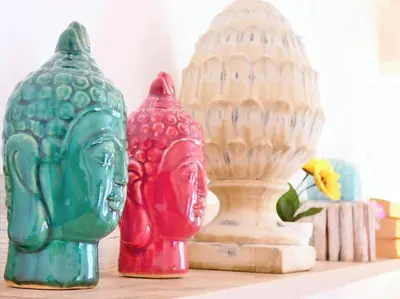two colorful vases sitting on a shelf next to a statue at Villa Indipendente Jacuzzi Giardino Clima WiFi in Castellammare del Golfo