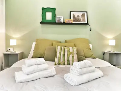 a pile of towels sitting on top of a bed at A Palermo Sono in Palermo