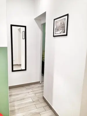 two framed mirrors on a white wall in a room at A Palermo Sono in Palermo