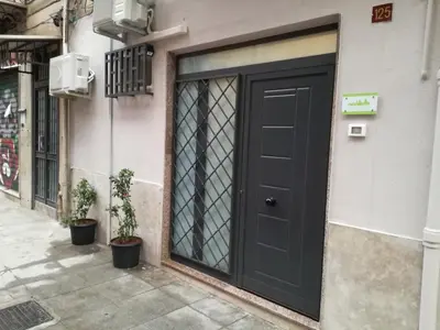 a black door on the side of a building at A Palermo Sono in Palermo