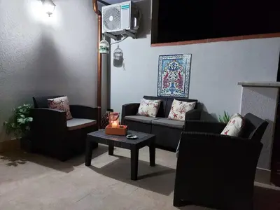 a living room with couches and a table with candles at Terrazza New Homes in Castellammare del Golfo