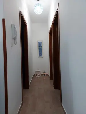 a hallway with two open doors and a hallway with a phone at Terrazza New Homes in Castellammare del Golfo