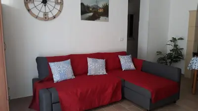 a red couch with pillows in a living room at Terrazza New Homes in Castellammare del Golfo