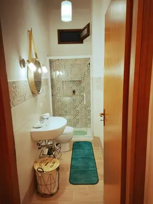 a bathroom with a sink and a toilet and a shower at Terrazza New Homes in Castellammare del Golfo