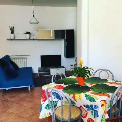 a living room with a table with a plant on it at Apartment in the center in Terrasini