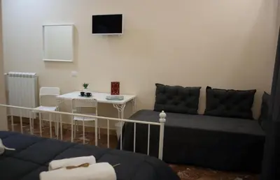 a living room with a couch and a table at Mantegna Rooms in Palermo