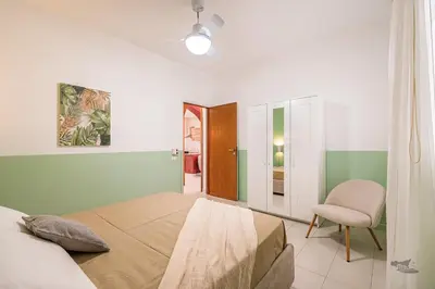 a bedroom with a bed and a chair at Villa DellAcqua in Alcamo Marina