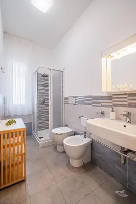 a bathroom with a toilet and a sink and a toilet istg at Villa DellAcqua in Alcamo Marina
