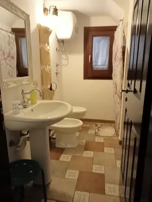a bathroom with a sink and a toilet at VILLA TREROSE by Trerose Properties - Villa centrale con wi-fi e posto auto privato gratuiti in San Vito lo Capo