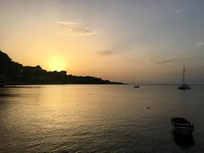 a sunset over a body of water with a boat at Casa Gagà in Sferracavallo