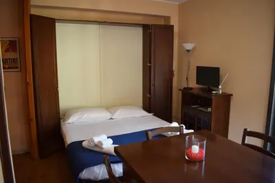 a hotel room with a bed and a table with a table at Casa Gagà in Sferracavallo