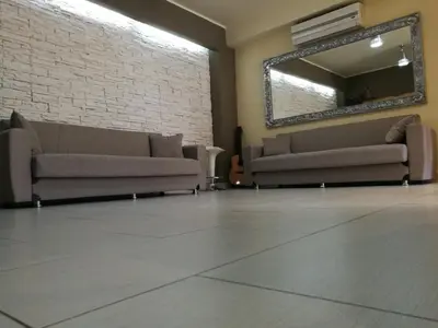 a living room with two couches and a mirror at Casa Valeria in Balestrate