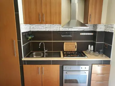 a kitchen with a sink and a stove top oven at Casa Valeria in Balestrate