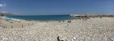 a group of people on a rocky beach at La Casetta di Andrea & Vale in Termini Imerese