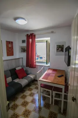 a living room with a couch and a table at Vivere la Ciambra in Monreale