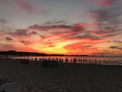 a sunset on a beach with the ocean at La maison sul mare in San Vito lo Capo